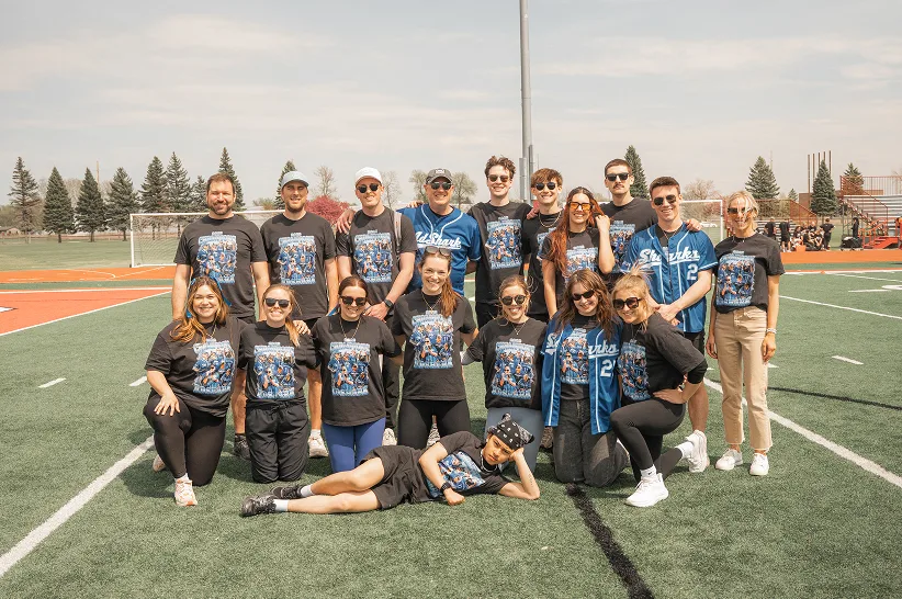 The AdShark team in matching shirts on the field at the Corporate Cup