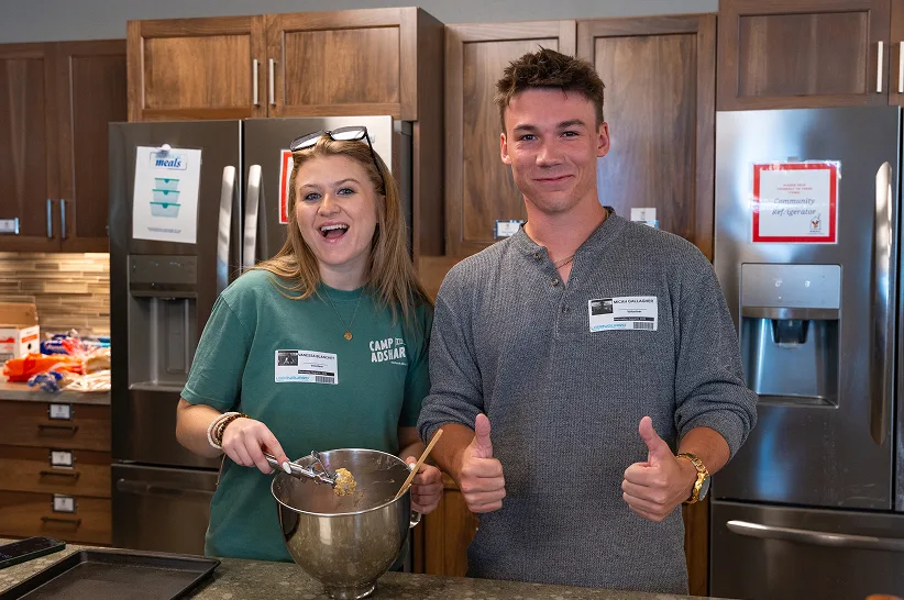 Micah and Vanessa baking during a team volunteer shift in a community kitchen