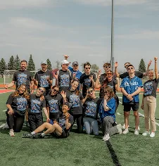 The AdShark team in matching shirts celebrating on a sports field