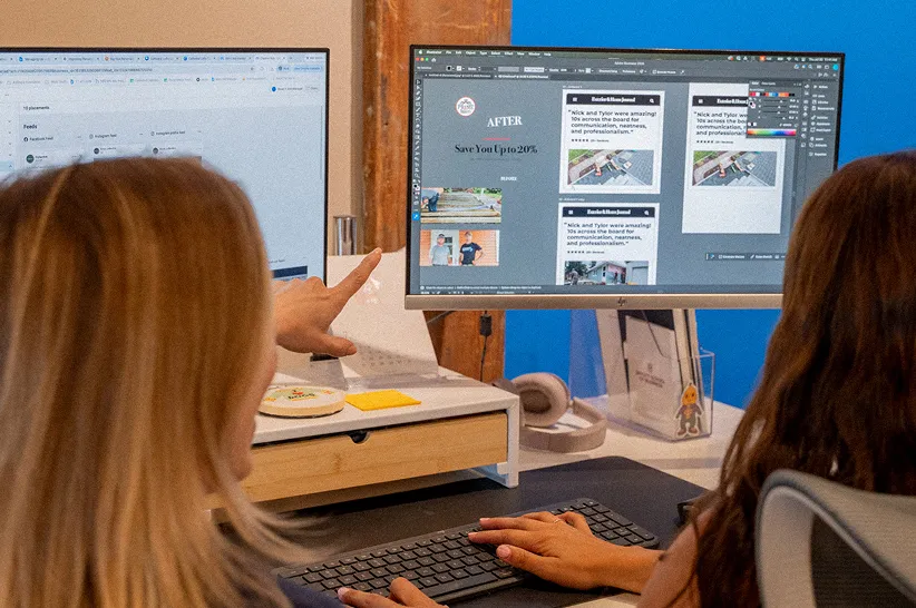 AdShark team reviewing ad creative on dual monitors