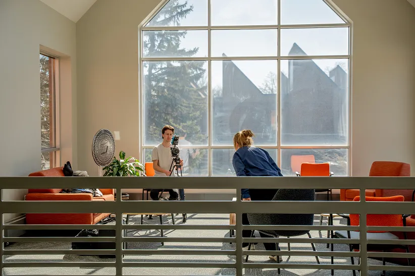 AdShark team on a video shoot beside a large window