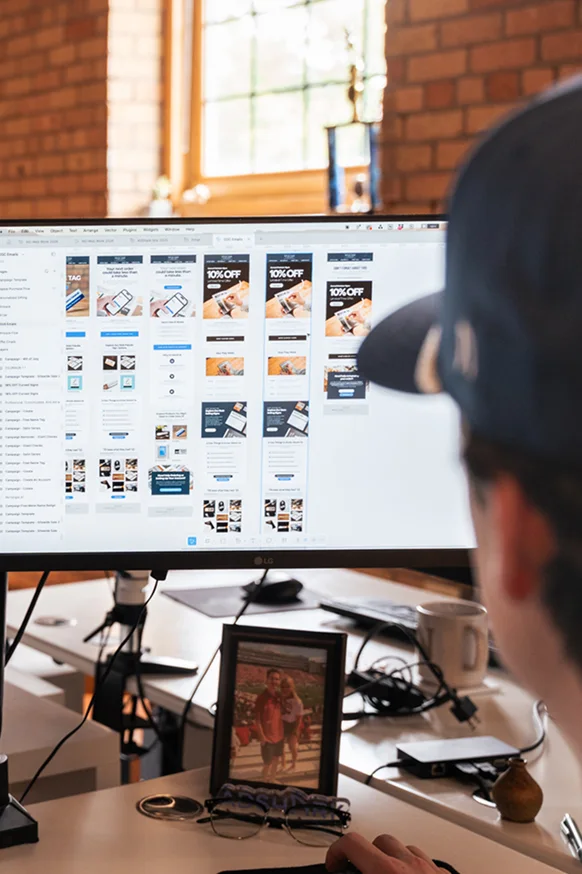 An AdShark designer laying out email templates on screen