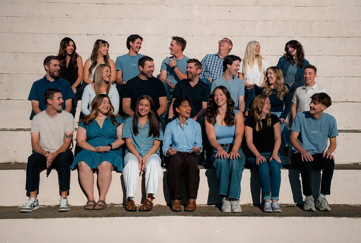 The AdShark team of 22 digital marketers, seated together outdoors