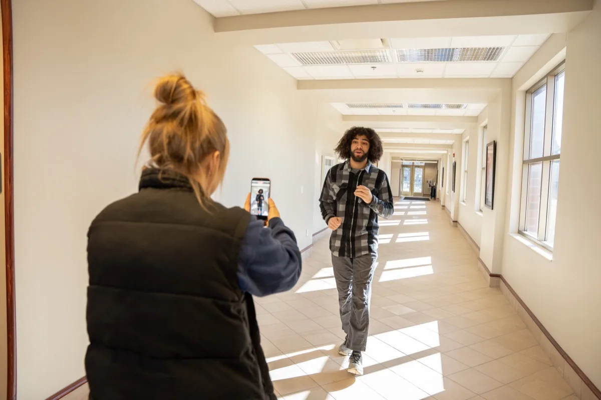 An AdShark creative filming a short-form social video on a phone