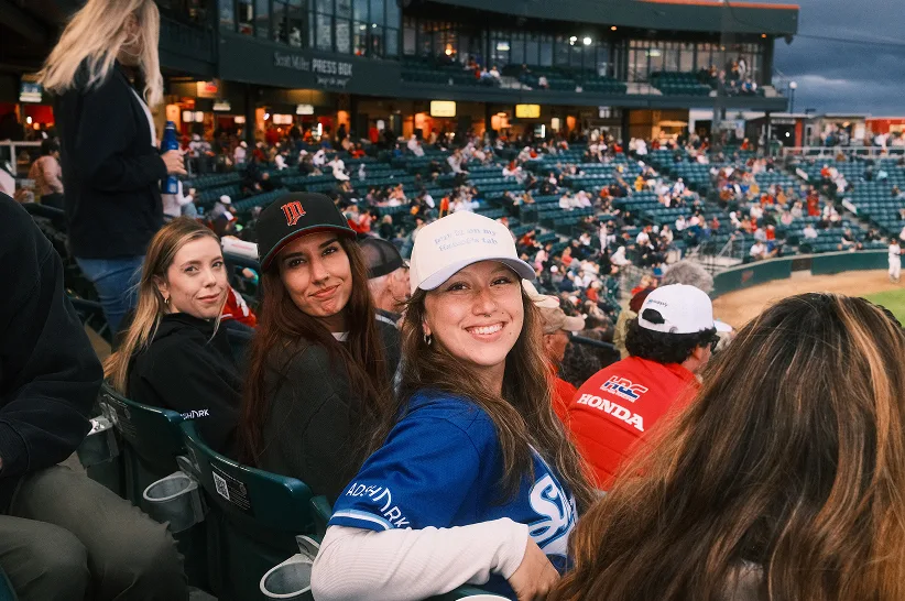 AdShark team members in the stands at a RedHawks baseball game