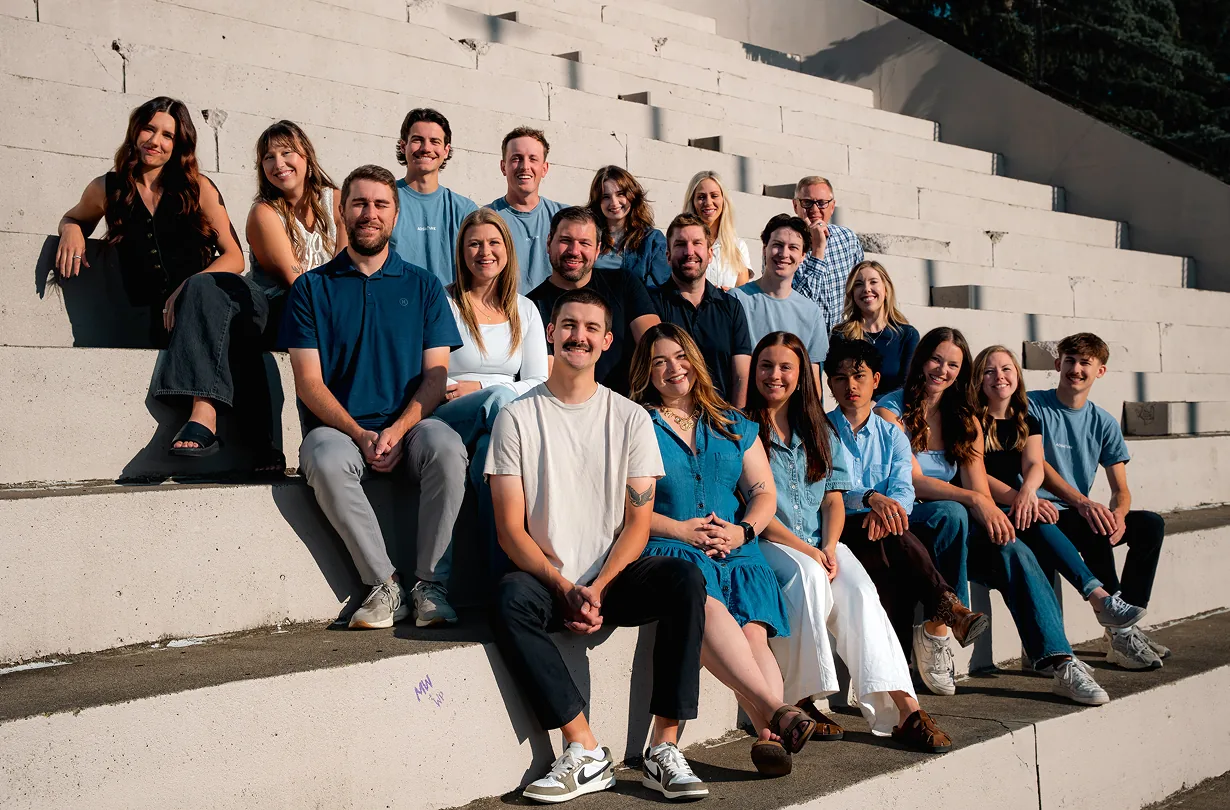 The AdShark team seated together on stadium steps
