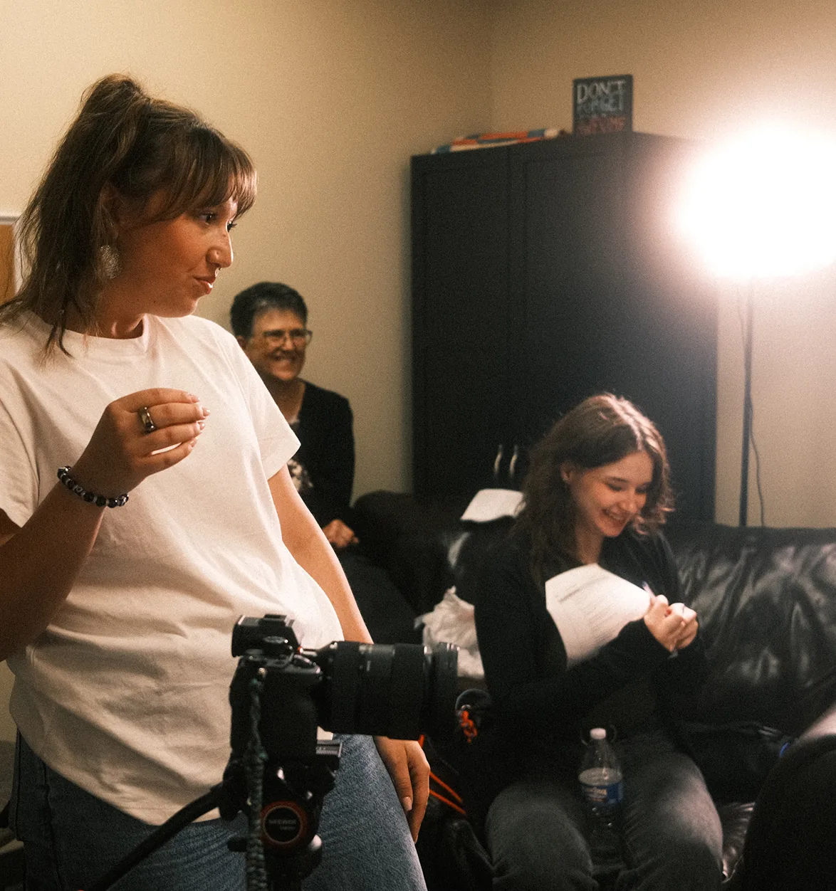 An AdShark director briefing talent on set during a video shoot